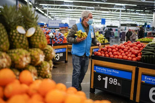 A worker carries bananas inside the Walmart Supercenter on Feb. 9, 2023, in North Bergen, New Jersey. Walmart reports earnings on Thursday, May 17, 2024. (AP Photo/Eduardo Munoz Alvarez, File)