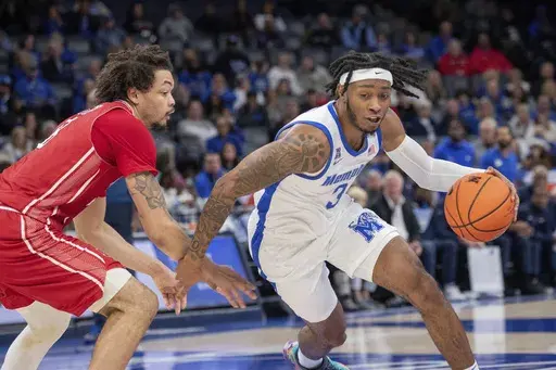 Arkansas State forward Kobe Julien, left, defends against Memphis guard Colby Rogers (3) during the first half of an NCAA college basketball game Sunday, Dec. 8, 2024, in Memphis, Tenn. (AP Photo/Nikki Boertman)