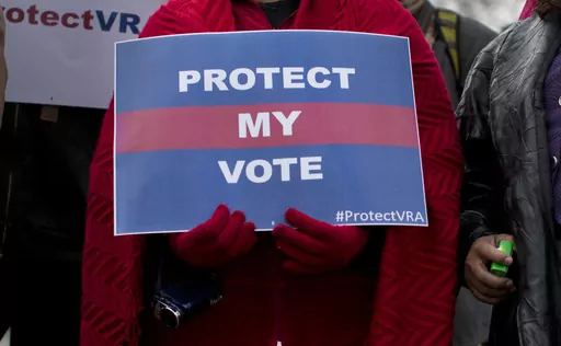 People wait in line outside the Supreme Court in Washington to listen to oral arguments in a voting rights case on Feb. 27, 2013. A U.S. Supreme Court decision a decade ago that tossed out the heart of the Voting Rights Act continues to reverberate across the country. Republican-led states continue to pass voting restrictions that, in several cases, would have been subject to federal review had the court left the provision intact. (AP Photo/Evan Vucci, File)