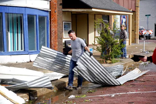 Tony Dowdy, of Victory Family Church, helps clean up tornado damage in Seminole, Okla. on Thursday, May, 5, 2022. A springtime storm system spawned several tornadoes that whipped through areas of Texas and Oklahoma, causing damage to a school, a marijuana farm and other structures.  (Sarah Phipps/The Oklahoman via AP)