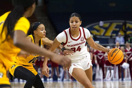 Arkansas' Chrissy Carr (34) drives the ball up the court against Missouri's Katlyn Gilbert (10) in the first half of an NCAA college basketball game during the Southeastern Conference women's tournament in Greenville, S.C., Thursday, March 2, 2023. (AP Photo/Mic Smith)