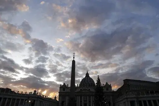 The sun sets behind St. Peter's Basilica, at the Vatican, Thursday, Dec. 5, 2019. The Vatican’s sprawling financial trial may not have produced any convictions yet or any new smoking guns. But recent testimony in May 2022 has provided plenty of insights into how the Vatican operates. (AP Photo/Gregorio Borgia, File)