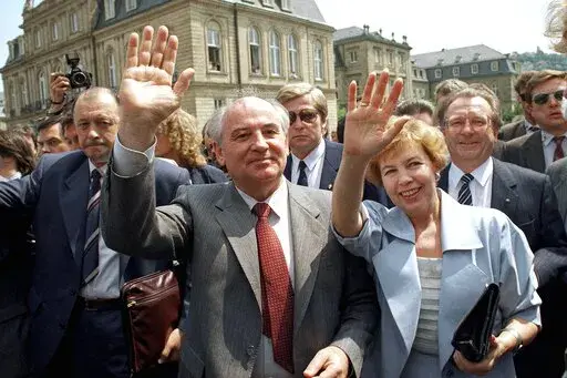 Soviet President Mikhail S. Gorbachev (l) and his wife Raisa wave to well wishers when strolling through market place in downtown Stuttgart, Wednesday, June 14, 1989. In background is the New Castle where Gorbachev had talks with representatives of West German state Baden-Wurttemberg. When Mikhail Gorbachev is buried Saturday at Moscow's Novodevichy Cemetery, he will once again be next to his wife, Raisa, with whom he shared the world stage in a visibly close and loving marriage that was unprece