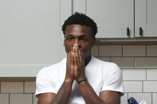 Armorion Smith, an NCAA football player at Michigan State, takes a moment by himself at home in Lansing, Mich., Tuesday, Sept. 3, 2024. (AP Photo/Paul Sancya)