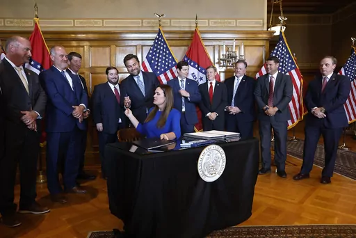 Arkansas Gov. Sarah Huckabee Sanders hands a pen to Sen. Jonathan Dismang, R-Beebe, after signing the tax cut bill on Thursday, Sept. 14, 2023, at the state Capitol in Little Rock Ark. (Thomas Metthe/Arkansas Democrat-Gazette via AP)