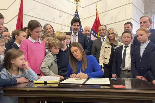 Arkansas Gov. Sarah Huckabee Sanders signs into law an education overhaul bill, Wednesday, March 8, 2023 at the state Capitol in Little Rock, Ark. The Arkansas Supreme Court on Thursday, Oct. 12, 2023, upheld the procedural vote that allowed Huckabee Sanders' education overhaul to take effect immediately, rejecting a judge's ruling that threw into question the way state laws have been fast-tracked into enforcement over the years. (AP Photo/Andrew DeMillo)