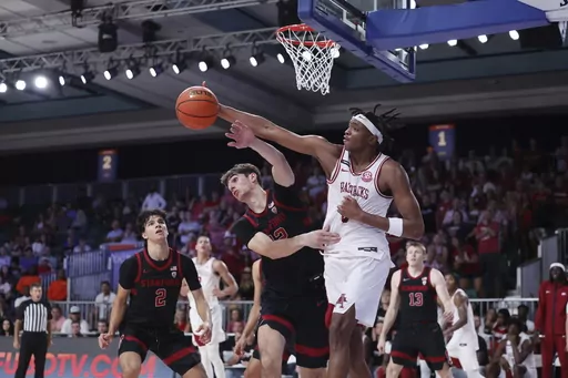 In a photo provided by Bahamas Visual Services, Arkansas's Chandler Lawson and Stanford's Maxime Raynaud clash during a rebound at the end of the second half of an NCAA college basketball game in the Battle 4 Atlantis at Paradise Island, Bahamas, Wednesday, Nov. 22, 2023. (Tim Aylen/Bahamas Visual Services via AP)