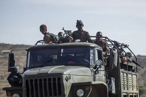 Ethiopian government soldiers ride in the back of a truck on a road near Agula, north of Mekele, in the Tigray region of northern Ethiopia on May 8, 2021. Authorities in Ethiopia's northern Tigray region alleged Wednesday, Aug. 24, 2022 that Ethiopia's military launched a "large-scale" offensive for the first time in a year, while Ethiopia's military spokesman did not immediately respond to questions. (AP Photo/Ben Curtis, File)