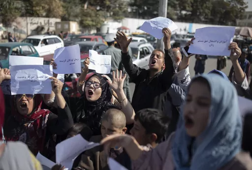 FILE-Afghan women chant during a protest in Kabul, Afghanistan, Thursday, Oct. 21, 2021. A U.K.-based rights group on Thursday, May 18, 2023 launched an interactive map documenting human rights abuses and violence against civilians since the Taliban seized power in Afghanistan nearly two years ago. (AP Photo/Ahmad Halabisaz, File)