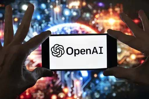 The OpenAI logo is displayed on a cell phone in front of an image generated by ChatGPT's Dall-E text-to-image model, Dec. 8, 2023, in Boston. (AP Photo/Michael Dwyer, File)