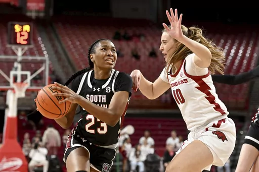 South Carolina guard Bree Hall (23) drives past Arkansas forward Cristina Sánchez Cerqueira (10) during the second half of an NCAA college basketball game Thursday, Feb. 29, 2024, in Fayetteville, Ark. (AP Photo/Michael Woods)