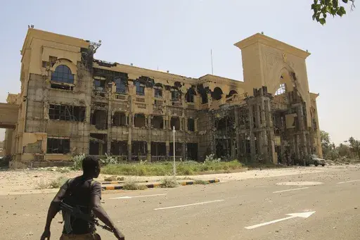 An army soldier walks in front of the Republican Palace in Khartoum, Sudan, after it was taken over by Sudan's army Friday, March 21, 2025. (AP Photo)