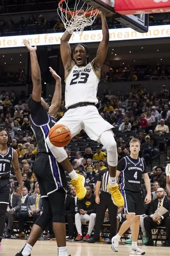 Missouri's Aidan Shaw (23) dunks over Central Arkansas' Ubongabasi Etim, left, during the second half of an NCAA college basketball game Saturday, Dec. 30, 2023, in Columbia, Mo. (AP Photo/L.G. Patterson)