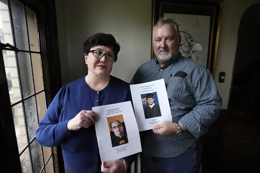 Karen Kobylik and her husband Michael Kobylik hold funeral programs for Karen's children Ruby and Bishop Taverner, Monday, May 1, 2023, in Pontiac, Mich. Ruby shot and killed her boyfriend and brother before taking her own life hours later on May 8, 2022. Kobylik had spent the weeks prior calling police asking them to remove her daughter's firearm. "They said we can't take any guns away from her because we cannot step on her second amendment right," Kobylik told The Associated Press. Michigan is
