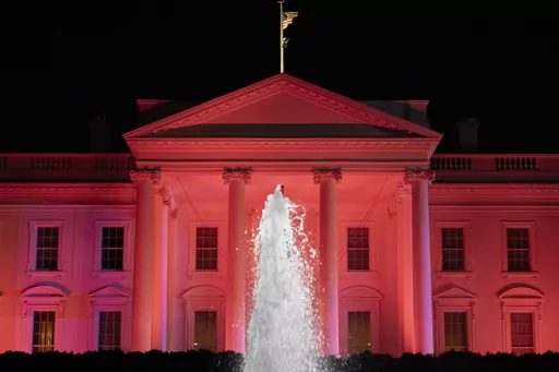 The White House is illuminated in pink for Breast Cancer Awareness Month, Thursday, Oct. 19, 2023, in Washington. (AP Photo/Andrew Harnik)