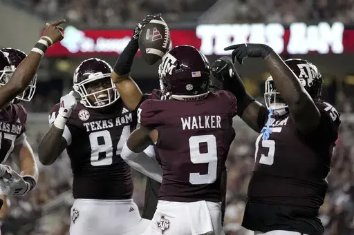 Texas A&M wide receiver Jahdae Walker (9) does a touchdown dance with teammates Tre Watson (84) and lineman Kam Dewberry (75) after scoring against Bowling Green during the second half of an NCAA college football game Saturday, Sept. 21, 2024, in College Station, Texas. (AP Photo/Sam Craft)