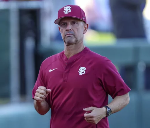 Florida State head coach Link Jarrett jogs to the dugout before an NCAA baseball game against Florida, March 12, 2024, in Gainesville, Fla. This season has been quite a bounce-back for Jarrett and the Seminoles, at least so far. The Seminoles are 18-0 and the only unbeaten team in Division I after sweeping Notre Dame at home over the weekend. (AP Photo/Gary McCullough, File)