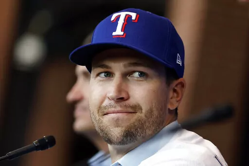 Texas Rangers pitcher Jacob deGrom listens during a baseball news conference at Globe Life Field in Arlington, Texas, on Dec. 8, 2022. The two-time Cy Young Award winner was held out of the first spring training workout Wednesday, Feb. 15, 2023 with the Rangers after their top free-agent acquisition felt some “tightness” in his left side. (Tom Fox/The Dallas Morning News via AP, File)