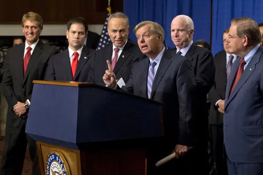 Sen. Lindsey Graham, R-S.C., center, speaks of immigration reform legislation outlined by the Senate's bipartisan "Gang of Eight" that would create a path for the nation's 11 million unauthorized immigrants to apply for U.S. citizenship, April 18, 2013, on Capitol Hill in Washington. From left are, Sen. Jeff Flake, R-Ariz., Sen. Marco Rubio, R-Fla., Sen. Charles Schumer, Graham, R-S.C., Sen. John McCain, R-Ariz., Sen. Robert Menendez, D-N.J., and Senate Majority Whip Richard Durbin, D-Ill. (AP P