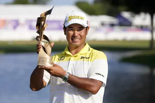 Hideki Matsuyama, of Japan, holds his trophy after winning the St. Jude Championship golf tournament Sunday, Aug. 18, 2024, in Memphis, Tenn. (AP Photo/Mark Humphrey)