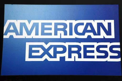 This Jan. 21, 2015, file photo, shows a sign for American Express outside a New York business. American Express launched its own checking account product on Tuesday, Feb. 8, 2022, a product that will allow its customers to accrue its popular Membership Rewards points the same way they do on its credit and charge cards.    (AP Photo/Mark Lennihan, File)