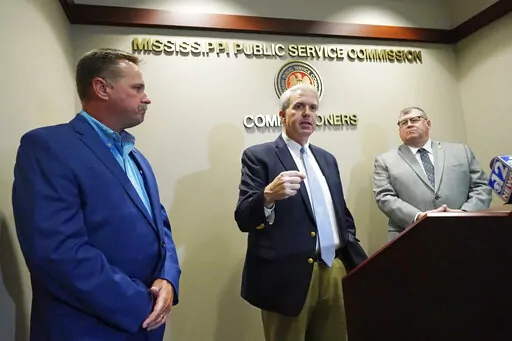 Northern District Public Service Commissioner Brandon Presley, center, speaks about the Mississippi Public Service Commission securing a $300 million settlement with Entergy Mississippi, a integrated energy company, Thursday, June 23, 2022, in Jackson, Miss. (AP Photo/Rogelio V. Solis)