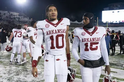 Arkansas quarterback Taylen Green (10) walks off the field with teammate KJ Jackson (15) after losing to Missouri in an NCAA college football game Saturday, Nov. 30, 2024, in Columbia, Mo. (AP Photo/L.G. Patterson)