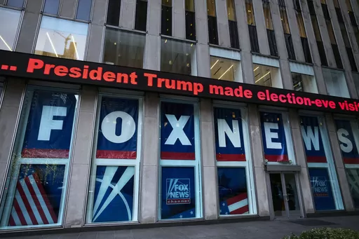 A headline about President Donald Trump is displayed outside Fox News studios in New York on Nov. 28, 2018. Dominion Voting Systems' defamation case against Fox News over its airing of false allegations about the 2020 presidential election will go to trial after a Delaware judge allowed a jury to decide whether the conservative network aired the claims with actual malice, the standard for proving libel. (AP Photo/Mark Lennihan, File)