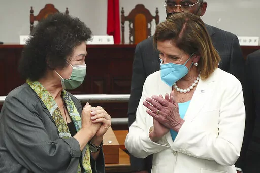 In this photo released by the Taiwan Ministry of Foreign Affairs, U.S. House Speaker Nancy Pelosi at right reacts to Chen Chu, the President of the Control Yuan and Chair of the National Human Rights Commission, during a visit to a human rights museum in Taipei, Taiwan on Wednesday, Aug. 3, 2022. U.S. House Speaker Nancy Pelosi, meeting leaders in Taiwan despite warnings from China, said Wednesday that she and other members of Congress in a visiting delegation are showing they will not abandon t