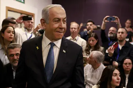 Israeli Prime Minister Benjamin Netanyahu arrives at the district court for his long-running trial for alleged corruption, in Tel Aviv, Israel, Tuesday, Dec. 10, 2024. (Menahem Kahana/Pool Photo via AP)