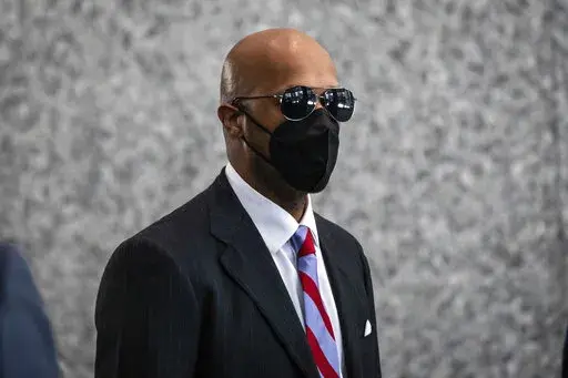 Milton "June" Brown walks walks into the Dirksen Federal Courthouse in Chicago as opening statements were expected to begin in R. Kelly's trial, Wednesday morning, Aug. 17, 2022. Two Kelly associates, Derrel McDavid and Milton Brown, are co-defendants. McDavid is accused of helping Kelly fix the 2008 trial, while Brown is charged with receiving child pornography. Like Kelly, they also have denied wrongdoing. (Ashlee Rezin/Chicago Sun-Times via AP)