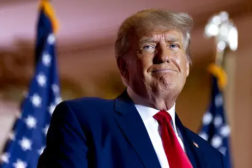 Former President Donald Trump announces he is running for president for the third time as he smiles while speaking at Mar-a-Lago in Palm Beach, Fla., Nov. 15, 2022. Trump's early announcement of his third White House bid won't shield the former president from the criminal investigations already confronting him as an ordinary citizen, leaving him legally and politically exposed as he seeks the 2024 Republican nomination. (AP Photo/Andrew Harnik, File)