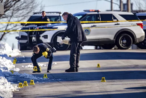 Police investigate a shooting outside of East High School in in Des Moines, Iowa, on Monday, March 7, 2022. (Zach Boyden-Holmes/The Des Moines Register via AP)