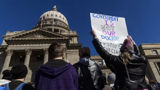 People gather in front of the Idaho Statehouse in opposition to anti-transgender legislation moving through an Idaho Republican congress, Friday, Feb. 24, 2023, in Boise, Idaho. The U.S. Supreme Court's decision on Monday, April 15, 2024, allows the state to put in place a 2023 law that subjects physicians to up to 10 years in prison if they provide hormones, puberty blockers or other gender-affirming care to people under age 18. A federal judge in Idaho had previously blocked the law in its ent