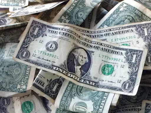 Dollar bills are shown in New York, Oct. 24, 2016. Our emotional reactions to money, based on past experiences and mistakes, can interfere with our ability to make smart money decisions today. To address those emotions, several new books advocate strategies such as conducting body check-ins, rewriting your own money story and reflecting on past financial mistakes. (AP Photo/Mark Lennihan, File)