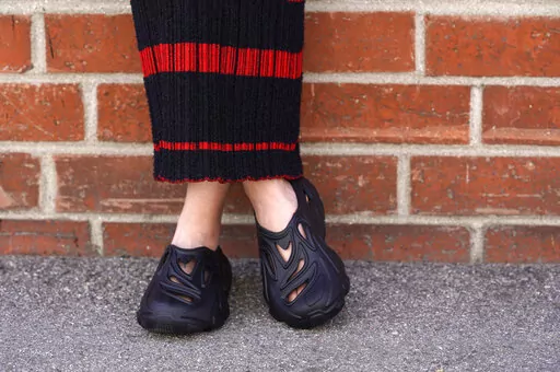Plastic Soul shoes are modeled outside the Doc Johnson factory and corporate offices, Thursday, Aug. 18, 2022, in Los Angeles. Streetwear label Rose in Good Faith and sex toy company Doc Johnson have partnered to create a shoe derived in part from unused or defective sex toys. (AP Photo/Chris Pizzello)