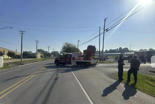 Emergency responders work the scene of semitruck crash in Teutopolis, Ill., on Saturday, Sept. 30, 2023. Federal regulators confirmed Saturday they are reviewing the crash of a semitruck carrying a toxic substance in central Illinois, resulting in “multiple fatalities” and dangerous air conditions that prompted the evacuation of area residents. (NewsNation-WTWO via AP)