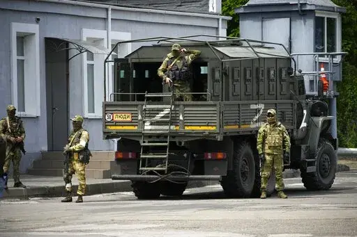 Russian soldiers guard an area as a group of foreign journalists visit in Kherson, Kherson region, south Ukraine, May 20, 2022. Russia’s military has announced that it’s withdrawing from Ukraine's southern city of Kherson and nearby areas. That would be another in a series of humiliating setbacks for Moscow’s forces in the 8-month-old war. This photo was taken during a trip organized by the Russian Ministry of Defense. (AP Photo, File)