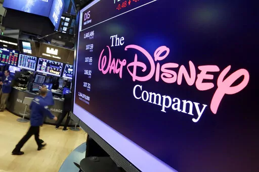 In this Aug. 8, 2017, file photo, The Walt Disney Co. logo appears on a screen above the floor of the New York Stock Exchange. Disney is working on sequels for its “Toy Story,” “Frozen” and “Zootopia” franchises as the company concentrates more on brands that have continued to perform well. The Walt Disney Co. is working on a “strategic transformation,” announced by CEO Bob Iger on Wednesday, Feb. 8 2023. (AP Photo/Richard Drew, File)