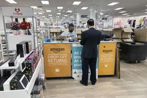 People return items purchased online at an Amazon counter inside a Kohl's department store in Clifton, New Jersey, on September 3, 2021. (AP Photo/Ted Shaffrey, File)