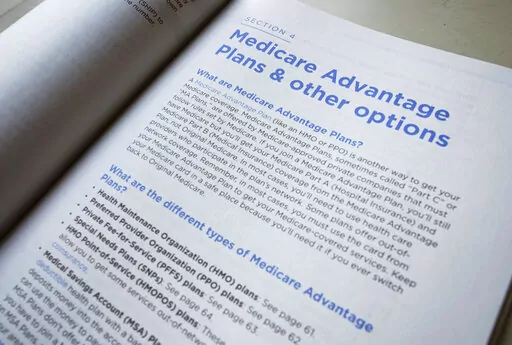 This Nov. 8, 2018 file photo shows a page from the 2019 U.S. Medicare Handbook in Washington. Medicare open enrollment starts soon, but 7 in 10 Medicare beneficiaries say they don’t compare Medicare plans during this period, which stretches from Oct. 15 to Dec. 7, 2022.  (AP Photo/Pablo Martinez Monsivais, File)