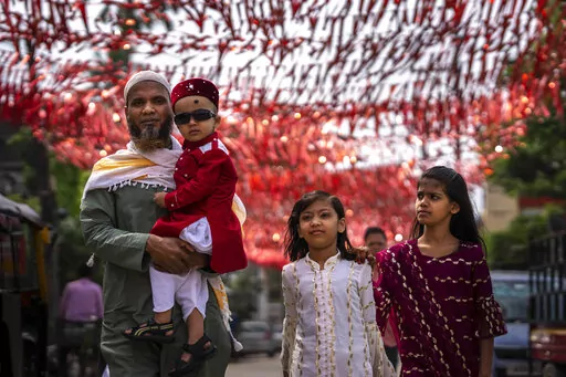 A Muslim family comes to offer Eid al-Fitr prayers in Gauhati, India, Tuesday, May 3, 2022. Eid al-Fitr marks the end of the fasting month of Ramadan. (AP Photo/Anupam Nath)