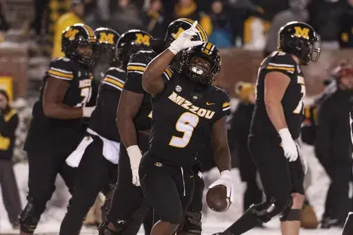 Missouri running back Marcus Carroll (9) celebrates after a touchdown during the second half of an NCAA college football game against Arkansas, Saturday, Nov. 30, 2024, in Columbia, Mo. (AP Photo/L.G. Patterson)