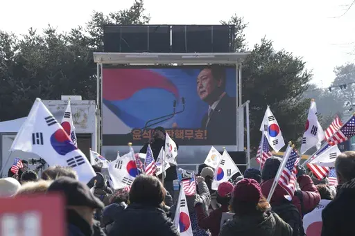 A picture of impeached South Korean President Yoon Suk Yeol is seen on the screen during a rally to oppose his impeachment outside a detention center in Uiwang, South Korea, Friday, Jan. 17, 2025. (AP Photo/Lee Jin-man)
