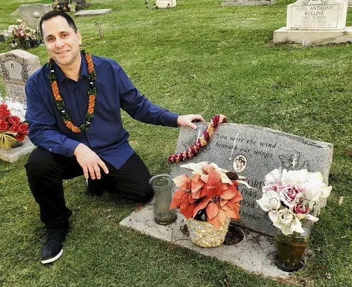 In this photo provided by Denise Cordeiro, Gordon Cordeiro, who spent 30 years in prison for a murder he said he didn't commit, visits the grave of his mother Friday, Feb. 21, 2025, in Makawao, Hawaii, hours after a judge ordered his release because of new evidence (Denise Cordeiro via AP)
