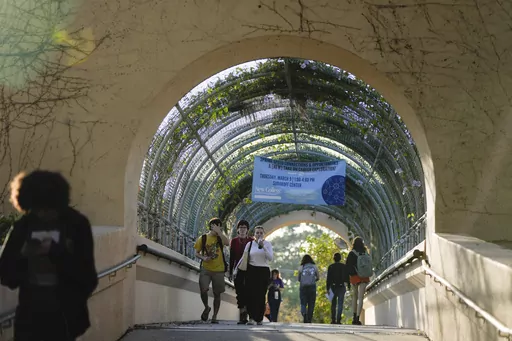 Students cross a bridge linking different sections of the campus, at New College of Florida, Tuesday, Feb. 28, 2023, in Sarasota, Fla. For years, students have come to this public liberal arts college on the western coast of Florida because they were self-described free thinkers. Now they find themselves caught in the crosshairs of America's culture war. (AP Photo/Rebecca Blackwell)