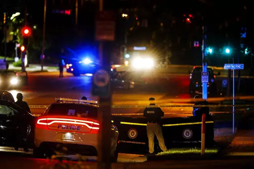 Memphis Police officers work an active shooter scene on Poplar Avenue in Memphis, Tenn. Wednesday, Sept. 7, 2022. Police in Memphis, Tennessee, said a man who drove around the city shooting at people during an hours-long rampage that forced frightened people to shelter in place Wednesday has been arrested. (Mark Weber/Daily Memphian via AP)