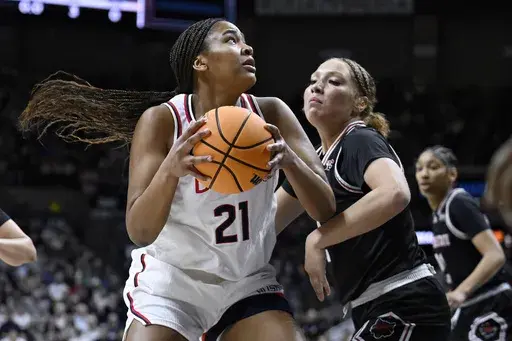 UConn forward Sarah Strong (21) is guarded by Arkansas State guard Wynter Rogers during the first half in the first round of the NCAA college basketball tournament, Saturday, March 22, 2025, in Storrs, Conn. (AP Photo/Jessica Hill)