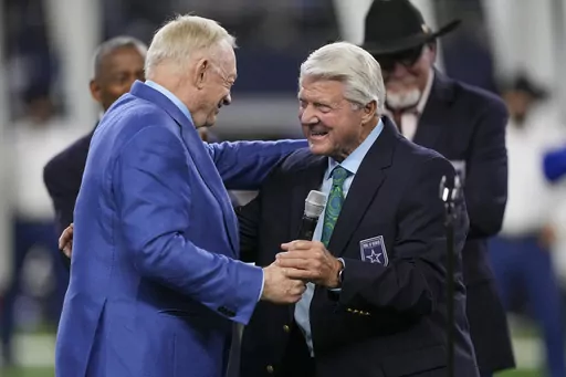 Dallas Cowboys owner Jerry Jones, left, talks with Pro Football Hall of Fame coach Jimmy Johnson after Johnson was inducted into the team's ring of honor during a ceremony at halftime of an NFL football game against the Detroit Lions, Saturday, Dec. 30, 2023, in Arlington, Texas. (AP Photo/Sam Hodde)