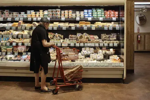A man shops at a supermarket on Wednesday, July 27, 2022, in New York.  An inflation gauge that is closely tracked by the Federal Reserve, Friday, July 29,  jumped 6.8% in June from a year ago, the biggest increase in four decades, and leaving Americans with no relief from surging costs.    (AP Photo/Andres Kudacki)